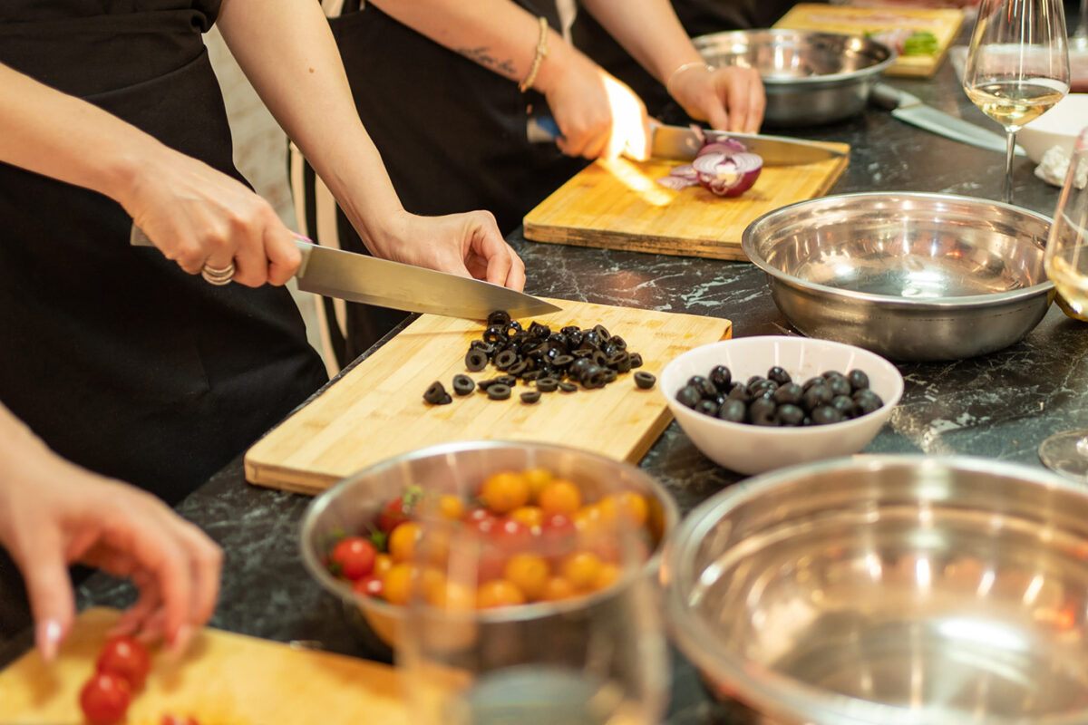 Cooking class, culinary, food and people concept, group of friends cooking in kitchen